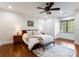Cozy bedroom with hardwood floors, soft lighting, neutral decor and a large window for natural light at 2100 Chesterfield Ave, Charlotte, NC 28205