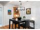 Open dining area with modern black table, art, modern lighting and built-in shelving at 2100 Chesterfield Ave, Charlotte, NC 28205
