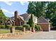 Beautiful brick home featuring a stone fence and manicured landscaping at 2100 Chesterfield Ave, Charlotte, NC 28205