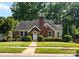 Charming brick home with a well-manicured lawn and mature trees at 2100 Chesterfield Ave, Charlotte, NC 28205