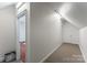 A finished hallway with carpet and doors leading to different areas of the home at 2100 Chesterfield Ave, Charlotte, NC 28205