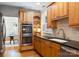 A kitchen with wood cabinets, granite countertops, and stainless steel double oven at 2100 Chesterfield Ave, Charlotte, NC 28205