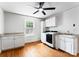 Laundry room featuring white cabinets, countertops, appliances and hardwood floors at 2100 Chesterfield Ave, Charlotte, NC 28205