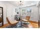 Brightly lit living room with modern chairs, hardwood floors, and neutral colors at 2100 Chesterfield Ave, Charlotte, NC 28205