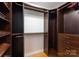 A closet with custom wood shelving and a variety of hanging spaces offers organization solutions at 2100 Chesterfield Ave, Charlotte, NC 28205