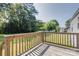 A wooden back deck is perfect for outdoor relaxation with a view of the backyard and trees at 2105 Florida Ave, Kannapolis, NC 28083