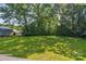 A lush green back yard is shaded by mature trees, offering a private outdoor space at 2105 Florida Ave, Kannapolis, NC 28083