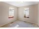 This bedroom features neutral walls, carpet, and two windows that allow natural light to fill the space at 2105 Florida Ave, Kannapolis, NC 28083