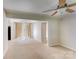 Bright living room with ceiling fan, carpet floors, and access to kitchen and dining area at 2105 Florida Ave, Kannapolis, NC 28083