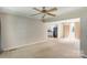 Bright living room with ceiling fan, carpet floors, and access to kitchen and sliding glass door at 2105 Florida Ave, Kannapolis, NC 28083