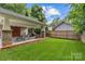 Backyard view showcasing a covered patio area, perfect for outdoor activities, and a well-maintained lawn at 2112 Shenandoah Ave, Charlotte, NC 28205