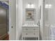 A clean bathroom with a vanity with drawers, a sink, a shower with glass doors, and an open medicine cabinet at 2112 Shenandoah Ave, Charlotte, NC 28205