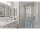 Bathroom with a glass shower, white vanity, and mirror for optimal use of space at 2112 Shenandoah Ave, Charlotte, NC 28205