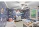 Charming bedroom features playful wallpaper, natural light, and ceiling fan at 2112 Shenandoah Ave, Charlotte, NC 28205