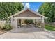 Large carport with stone pillars and ample room, adjoining a manicured lawn and garden at 2112 Shenandoah Ave, Charlotte, NC 28205