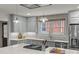 Well-lit kitchen with custom cabinets, a center island cooktop, and stainless steel refrigerator at 2112 Shenandoah Ave, Charlotte, NC 28205