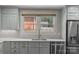 Updated kitchen with stainless steel appliances, custom cabinets, and windows bringing in natural light at 2112 Shenandoah Ave, Charlotte, NC 28205