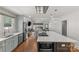 Open-concept kitchen with stainless steel appliances, island cooktop, and seamless flow into the living area at 2112 Shenandoah Ave, Charlotte, NC 28205