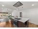 Open kitchen with island cooktop, stainless steel appliances, and seamless flow into the living area at 2112 Shenandoah Ave, Charlotte, NC 28205