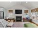 Bright living room with fireplace, large windows, and a seating bench at 2112 Shenandoah Ave, Charlotte, NC 28205
