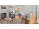 Cozy living room with a fireplace, built-in bookcases, hardwood floors, and seamless flow into the dining room at 2112 Shenandoah Ave, Charlotte, NC 28205