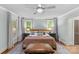 Serene bedroom featuring hardwood floors, a ceiling fan, and soft natural light at 2112 Shenandoah Ave, Charlotte, NC 28205