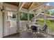 Inviting screened-in porch with wood ceiling, a table with 4 chairs and view of the well-maintained backyard at 2112 Shenandoah Ave, Charlotte, NC 28205