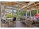 Cozy screened porch with comfortable seating, dining table, and swing at 2112 Shenandoah Ave, Charlotte, NC 28205