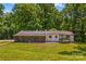 Expansive back exterior showing the back of the home with screened porch and spacious yard, nestled among lush trees at 2229 Old Wilkesboro Rd, Statesville, NC 28625