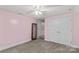 Carpeted bedroom with closet and large framed mirror at 2229 Old Wilkesboro Rd, Statesville, NC 28625