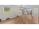 Hardwood floors lead to white kitchen in open plan dining room at 2229 Old Wilkesboro Rd, Statesville, NC 28625