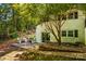 Home exterior with two benches outside of a sliding door surrounded by lush green trees at 2229 Old Wilkesboro Rd, Statesville, NC 28625