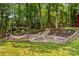 Secluded backyard featuring a hammock, stone water feature, and lush landscaping, creating a serene outdoor retreat at 2229 Old Wilkesboro Rd, Statesville, NC 28625