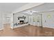 Inviting living room featuring a brick fireplace, hardwood floors, and ample natural light at 2229 Old Wilkesboro Rd, Statesville, NC 28625