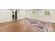 Hardwood floors and accent rug in living room with three windows and exterior door at 2229 Old Wilkesboro Rd, Statesville, NC 28625