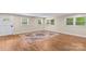 Bright living room with hardwood floors, neutral walls, and a decorative rug at 2229 Old Wilkesboro Rd, Statesville, NC 28625