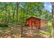 View of outbuilding with animal pen, surrounded by lush green trees, offering a country atmosphere at 2229 Old Wilkesboro Rd, Statesville, NC 28625