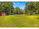 Spacious backyard featuring well-maintained greenery, outbuildings, and a wooded perimeter offering privacy and natural beauty at 2229 Old Wilkesboro Rd, Statesville, NC 28625