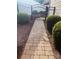 Long brick pathway with iron gate, mature bushes, and manicured landscaping, adding privacy and charm at 2300 Wednesbury Ct, Kannapolis, NC 28083