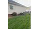 A well-maintained backyard with green grass, bushes, AC unit and a fence at 2300 Wednesbury Ct, Kannapolis, NC 28083