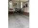 Clean garage with epoxy flooring, brick accent walls, shelving, and natural light from the windows at 2300 Wednesbury Ct, Kannapolis, NC 28083