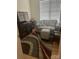 Cozy living room featuring a comfortable couch, ottoman, and area rug at 2300 Wednesbury Ct, Kannapolis, NC 28083
