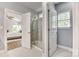 Modern bathroom showcasing a glass-enclosed shower and seamless transition to the main bedroom area at 2816 Woodlands Creek Dr, Monroe, NC 28110