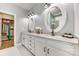 Elegant bathroom featuring a double sink vanity, framed mirrors, and stylish lighting for a spa-like experience at 2816 Woodlands Creek Dr, Monroe, NC 28110