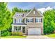 Charming two-story home with a stone-accented facade, black shutters, and a well-manicured front yard at 2816 Woodlands Creek Dr, Monroe, NC 28110