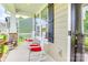 Front porch featuring white rocking chairs with red cushions at 2816 Woodlands Creek Dr, Monroe, NC 28110