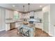 Well-appointed kitchen featuring granite counters, stainless appliances, tile backsplash and a central island with barstool seating at 2816 Woodlands Creek Dr, Monroe, NC 28110