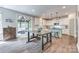 Stylish kitchen with white cabinets, an island with seating, and a sliding door to the outdoor space at 2816 Woodlands Creek Dr, Monroe, NC 28110