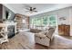 Cozy living room with a fireplace, wood accent wall, comfortable seating, and natural light at 2816 Woodlands Creek Dr, Monroe, NC 28110