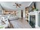 Bright living room featuring a fireplace, modern decor, open layout, and seamless flow to the kitchen at 2816 Woodlands Creek Dr, Monroe, NC 28110
